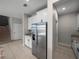 Spacious kitchen with stainless steel refrigerator and white cabinetry at 13735 Wineberry Dr, Dade City, FL 33525