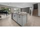 Kitchen island with granite countertops and stainless steel appliances and staircase to upper level at 13735 Wineberry Dr, Dade City, FL 33525