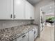 Bright kitchen features granite countertops and white cabinetry at 13735 Wineberry Dr, Dade City, FL 33525
