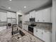 Bright kitchen features stainless steel appliances, granite countertops, white cabinets and a large island with a sink at 13735 Wineberry Dr, Dade City, FL 33525