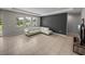 Bright living room boasts a modern white sectional sofa, neutral tile flooring, and large windows offering natural light at 13735 Wineberry Dr, Dade City, FL 33525