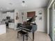 Living room with piano and view to the kitchen at 13735 Wineberry Dr, Dade City, FL 33525