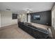 Upstairs living room with comfortable seating and dark accent wall with mounted tv at 13735 Wineberry Dr, Dade City, FL 33525