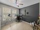 Office with ceiling fan and accent wall, and telescope at 13735 Wineberry Dr, Dade City, FL 33525