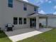 Covered patio with seating, barbecue, and lawn at 13735 Wineberry Dr, Dade City, FL 33525