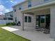 Covered patio with seating, barbecue, and lawn at 13735 Wineberry Dr, Dade City, FL 33525