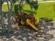 Community playground with ladders, yellow slides and climbing wall for to enjoy time outdoor, near neighborhood houses at 13735 Wineberry Dr, Dade City, FL 33525