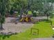 Community playground featuring slides, swings, and picnic tables, surrounded by lush greenery and mature oak trees at 13735 Wineberry Dr, Dade City, FL 33525