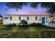 Charming single-story home with vibrant blue shutters and door, complemented by a manicured front yard at 1529 Essex N Dr, St Petersburg, FL 33710