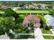 Stunning aerial view of a charming home with lush landscaping, a spacious driveway, and a tile roof at 1649 Ledgestone Dr, Brandon, FL 33511