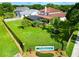 Overhead shot of house, large backyard, screened pool, and neighborhood entrance sign at 1649 Ledgestone Dr, Brandon, FL 33511
