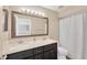 Functional bathroom featuring a double sink vanity with dark wood cabinets, a large mirror, and shower with tub at 1649 Ledgestone Dr, Brandon, FL 33511