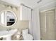 Bathroom with a pedestal sink, framed mirror, and glass shower door at 1649 Ledgestone Dr, Brandon, FL 33511