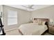 Cozy bedroom featuring neutral tones, a ceiling fan, and a window with blinds at 1649 Ledgestone Dr, Brandon, FL 33511