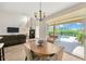 Cozy dining area with access to the screened-in pool and living room at 1649 Ledgestone Dr, Brandon, FL 33511