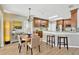 Cozy kitchen and dining area with hardwood floors, stainless steel appliances, and bar seating at 1649 Ledgestone Dr, Brandon, FL 33511