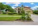 Beautiful two-story home with a well-manicured lawn and lush landscaping at 1649 Ledgestone Dr, Brandon, FL 33511