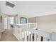 Bright and airy hallway with white banisters that overlook the entry way and opens to a bedroom at 1649 Ledgestone Dr, Brandon, FL 33511