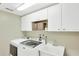 Efficient laundry room equipped with modern appliances, cabinets, and a utility sink at 1649 Ledgestone Dr, Brandon, FL 33511