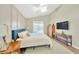 Comfortable bedroom featuring neutral walls, vaulted ceiling, wood furniture, ceiling fan and a cozy bed and decorative pillows at 1649 Ledgestone Dr, Brandon, FL 33511