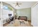 Comfortable office space with a large window, ceiling fan, and stylish decor at 1649 Ledgestone Dr, Brandon, FL 33511