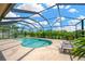Private screened-in pool surrounded by lush landscaping and ample deck space at 1649 Ledgestone Dr, Brandon, FL 33511