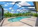 Spacious screened-in pool area with ample seating and privacy landscaping at 1649 Ledgestone Dr, Brandon, FL 33511