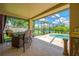 Extended covered patio with outdoor dining and views of the screened-in pool at 1649 Ledgestone Dr, Brandon, FL 33511