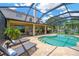 Relaxing screened-in pool area with lounge chairs on a sunny day at 1649 Ledgestone Dr, Brandon, FL 33511