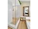 Stylish bathroom featuring a frameless shower, river rock floor, white subway tile, and a teak accent bench at 1649 Ledgestone Dr, Brandon, FL 33511