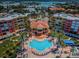 Stunning aerial view of condos with a large pool, palm trees, and beautiful landscaping at 16600 Gulf Blvd # 437, North Redington Beach, FL 33708