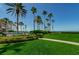 Professionally landscaped backyard, great lawn with lush green grass and pool at 16600 Gulf Blvd # 437, North Redington Beach, FL 33708