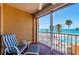 Relaxing balcony featuring a lounge chair with ocean views and palm trees at 16600 Gulf Blvd # 437, North Redington Beach, FL 33708