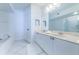 Bright bathroom featuring a dual sink vanity, tile flooring, and a separate tub and shower at 16600 Gulf Blvd # 437, North Redington Beach, FL 33708