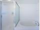 Bright bathroom featuring a separate tub and shower with glass door at 16600 Gulf Blvd # 437, North Redington Beach, FL 33708