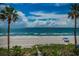 Stunning beach views with palm trees, white sand, and blue ocean at 16600 Gulf Blvd # 437, North Redington Beach, FL 33708