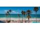 Beautiful beach view with palm trees and turquoise ocean waters at 16600 Gulf Blvd # 437, North Redington Beach, FL 33708