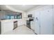 Well-lit kitchen with stainless steel appliances, white cabinets, and an open layout to the living area at 16600 Gulf Blvd # 437, North Redington Beach, FL 33708