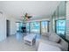 Bright living room with tile flooring, large windows showcasing beach and ocean views at 16600 Gulf Blvd # 437, North Redington Beach, FL 33708