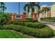 An attractive sign for Tides Beach Club is framed by lush greenery and palm trees on a bright, sunny day at 16600 Gulf Blvd # 437, North Redington Beach, FL 33708