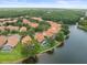 Breathtaking aerial view showcases the community with lush landscaping, lake views, and tile roofs at 18917 Avenue Biarritz, Lutz, FL 33558