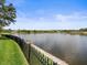 Expansive backyard with waterfront view and black metal fence at 18917 Avenue Biarritz, Lutz, FL 33558