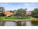 Aerial view of backyard with enclosed pool and black metal fence along the water at 18917 Avenue Biarritz, Lutz, FL 33558