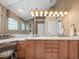 Bathroom featuring a dual sink vanity with granite countertops and a glass enclosed shower at 18917 Avenue Biarritz, Lutz, FL 33558
