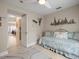 Cozy bedroom with lots of natural light, hardwood floors, and modern ceiling fan at 18917 Avenue Biarritz, Lutz, FL 33558
