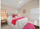 Comfortable bedroom with a ceiling fan, bright windows, and decorative accents create a relaxing space at 18917 Avenue Biarritz, Lutz, FL 33558