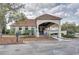 Exterior view of the clubhouse featuring covered entrance, landscaped grounds and accessible parking at 18917 Avenue Biarritz, Lutz, FL 33558