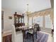 Elegant dining room featuring a wood table, chandelier, and decorative hutch for sophisticated entertaining at 18917 Avenue Biarritz, Lutz, FL 33558