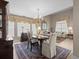 Classic dining room featuring a beautiful chandelier, tile flooring, and stylish window treatments at 18917 Avenue Biarritz, Lutz, FL 33558