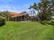 Well-manicured lawn with an enclosed pool area at 18917 Avenue Biarritz, Lutz, FL 33558